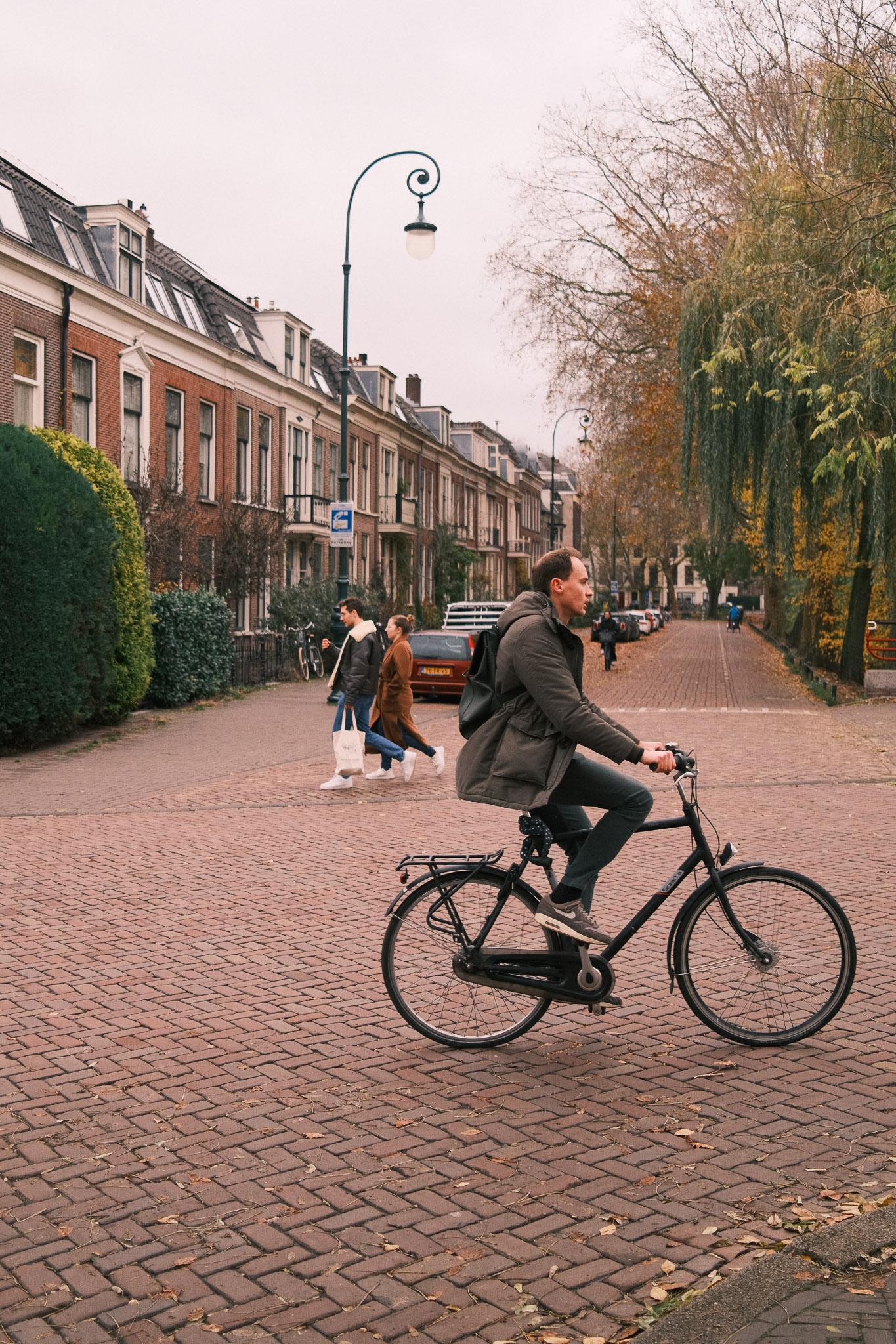 man on a bike with people in background walking opposite direction