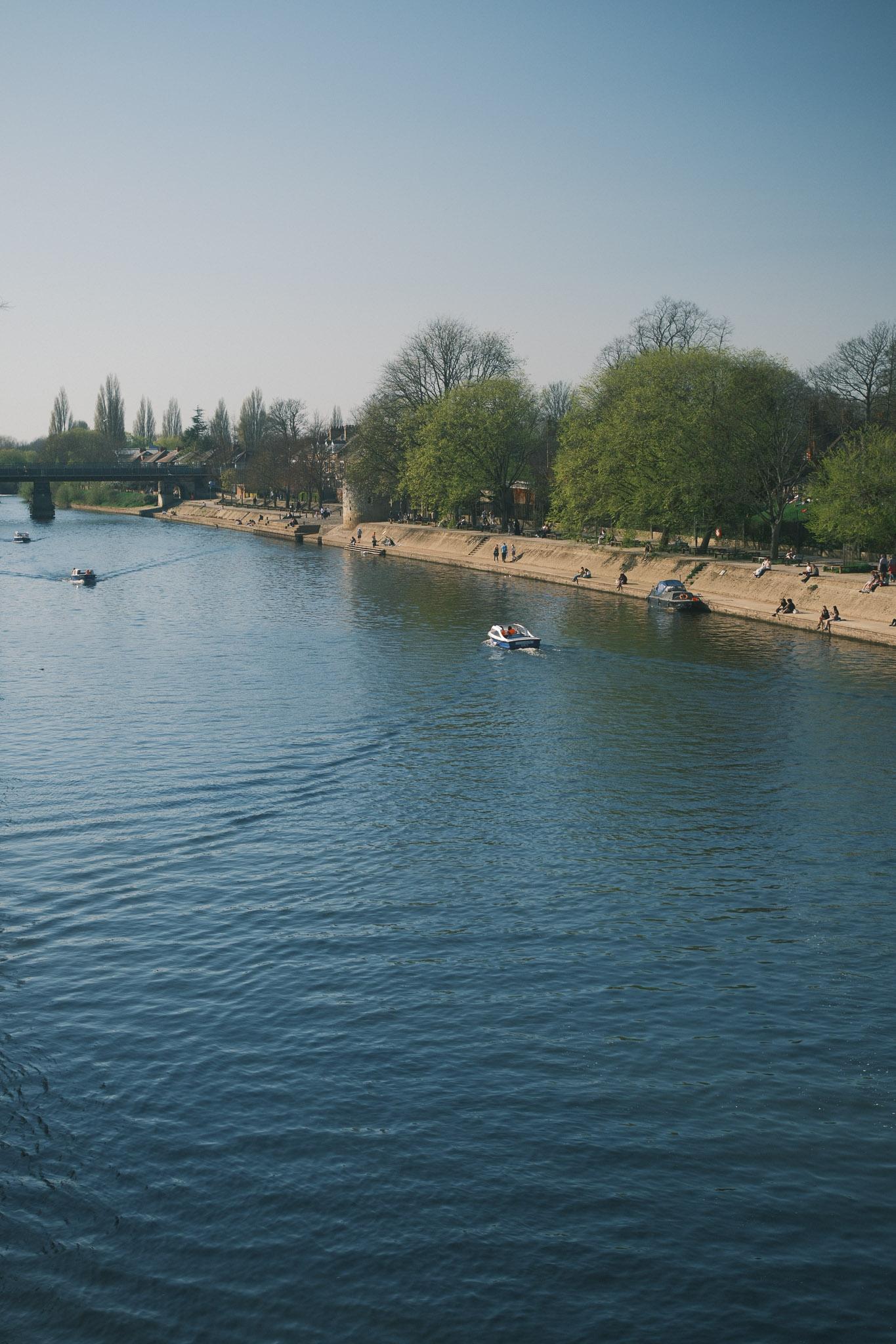 the beautiful River Ouse in York with people going up and down in boats
